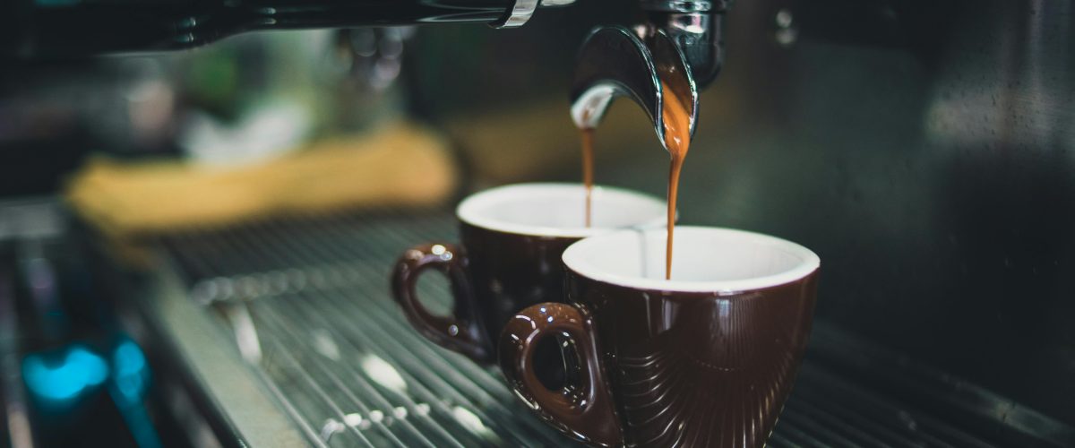 Espresso shots being poured from a coffee machine