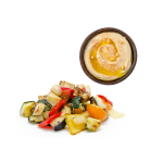 Roasted vegetables, next to a pot of hummus