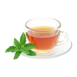 A glass mug full of herbal tea, with some mint leaves on the side.